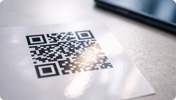Person scanning a dynamic QR code on a table